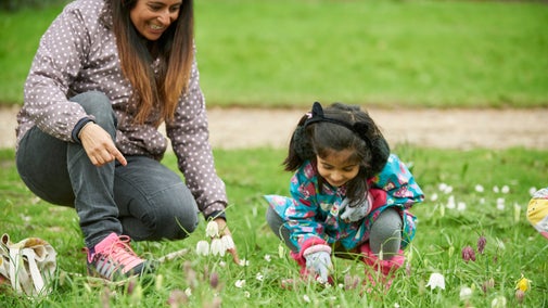 Family taking a closer look at spring flowers